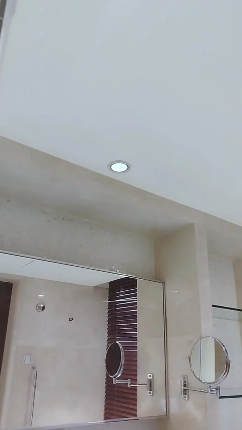 Modern bathroom interior with ceiling lights, mirrors, and wooden blinds, Stock Footage 338287677