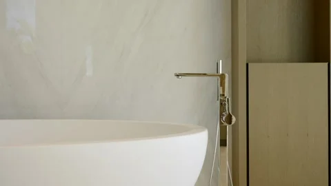 Modern bathroom interior with focus on a sleek minimalist faucet. Metallic Stock Footage 293850032