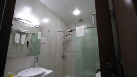 Modern bathroom with light white dressing table, mirror frame and accessories. 库存影片 196151344