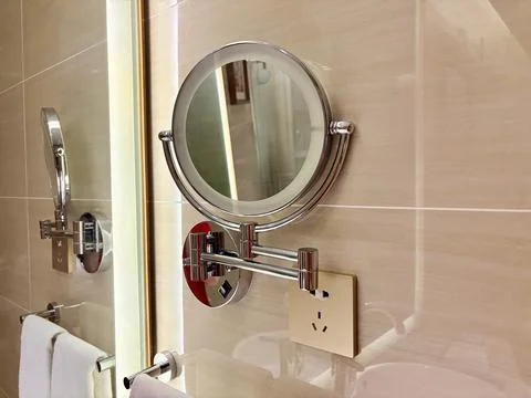 Modern Bathroom Mirror with Adjustable Arm and Power Outlet Foto stock