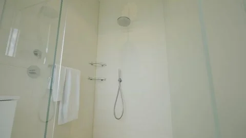 This modern bathroom shower features a clean, elegant design for a refreshing Stock Footage 285795104