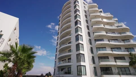 Modern beachfront condos with pool, lush palms, sea view for investment, real Stock Footage 269994755