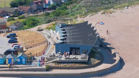 Modern beachside cafe with bold architecture. Crowded parking lot behind the Stock Footage 342025417