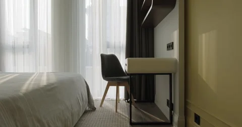 Modern bedroom with bed vanity table chair curtains yellow wall. Modern Stock Footage 277958867