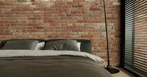 Modern Bedroom with Comfy Bed and Brick Wall Interior Stock Footage 310682940