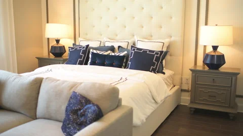 Modern bedroom, sofa couch bed with pillow comforter by window nightstand lamp Stock Footage 203853755