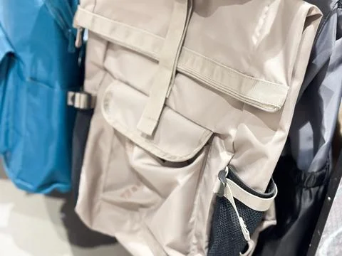 Modern Beige Roll-Top Backpack with Functional Pockets and Urban Design Stock Photos