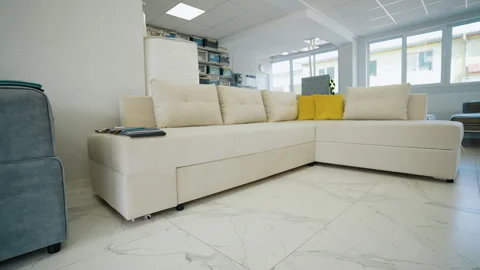 Modern Beige Sofa with Yellow Accent Pillows in Showroom Stock Footage 291733338