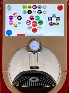 Modern beverage dispenser with digital interface showing various drink brands Stock Photos