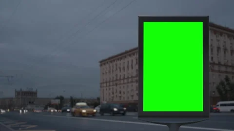 Modern billboard with a green screen on a busy defocused city highway with Video stock 156208317