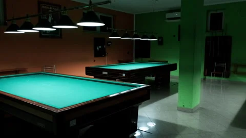 Modern billiard hall overview with multiple tables and stylish lighting Stock Footage 316336248