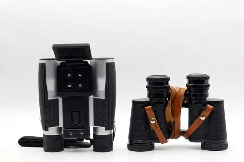 Modern binoculars with digital screen and vintage binoculars. Stock Photos