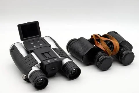 Modern binoculars with digital screen and vintage binoculars. Stock Photos