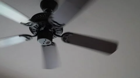 Modern black and wooden ceiling fan spinning rapidly Stock Footage 346275563