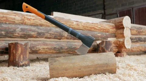 Modern black axe lies in a large pile of sawdust. Close-up of the cutting part Stock Footage 69043355