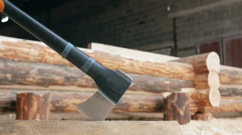 Modern black axe lies in a large pile of sawdust. Close-up of the cutting part Stock Footage 69043655