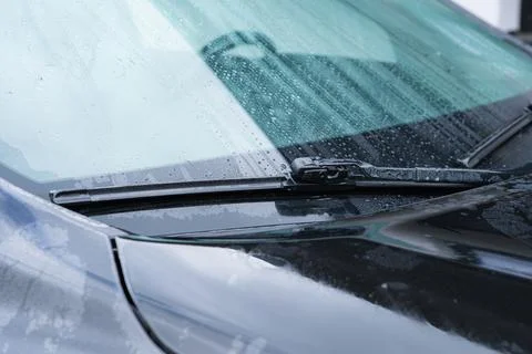 Modern black car windshield featuring high quality rubber wiper blades rest.. Stock Photos