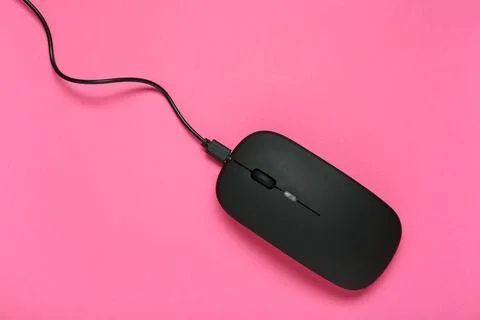 Modern black computer mouse on pink background Stock Photos