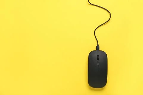 Modern black computer mouse on yellow background Stock Photos