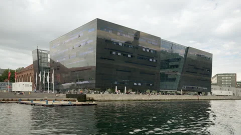 Modern Black Diamond Royal Library building on Copenhagen harbor waterfront Stock Footage 345446292