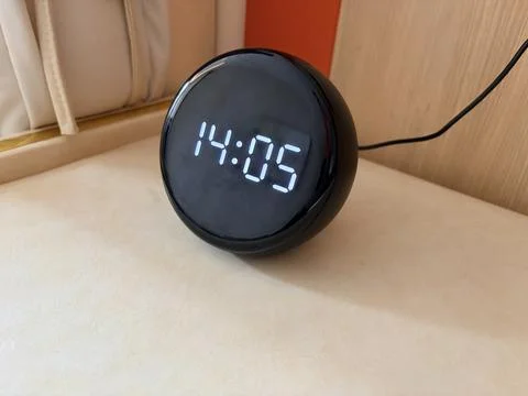 Modern black digital clock on a white surface. Stock-Fotos