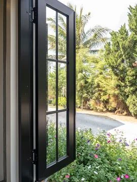 Modern Black Frame Window Open to Tropical Garden Stock Photos