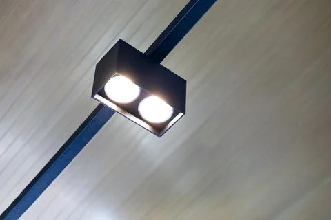 Modern black LED track light mounted on a ceiling rail, providing bright fo.. Stock Photos