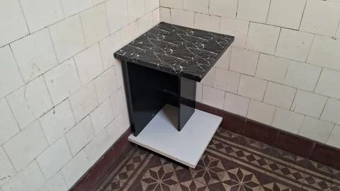 Modern black marble side table standing in room corner Stock Photos