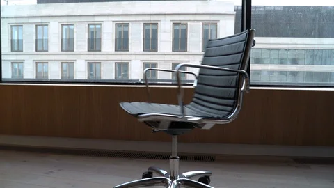 Modern black office chair loop rotate on skyscraper background Stock Footage 129061829