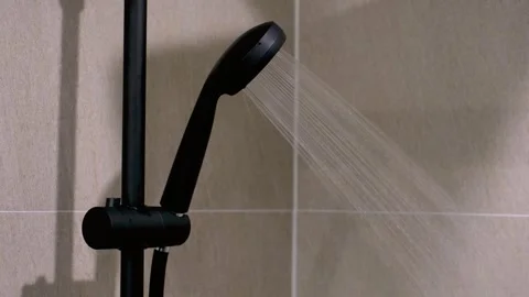 Modern black shower on the background of tiles in the bathroom close-up. Stock Footage 290479135