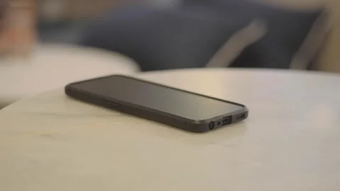 Modern Black Smartphone Resting on a White Marble Table. lost smart phone Stock Footage 334697293