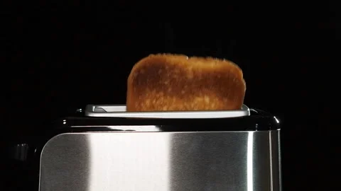 Modern black toaster with a bread. Stock Footage 130425950