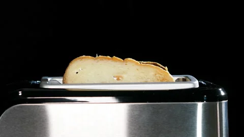Modern black toaster with a bread. Stock Footage 130425968