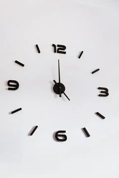Modern Black Wall Clock on White Background Stock Photos