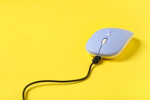 Modern blue computer mouse on yellow background Stock Photos