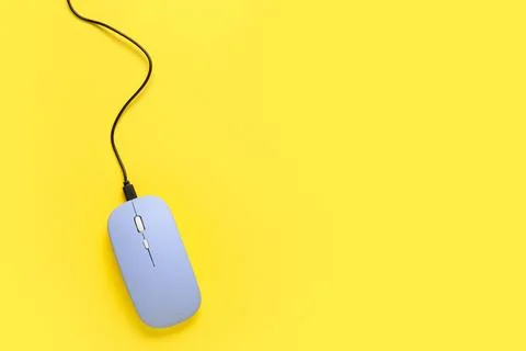 Modern blue computer mouse on yellow background Stock Photos