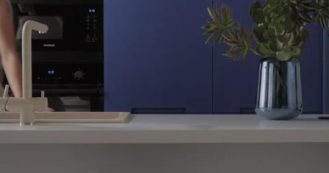 Modern blue kitchen interior design with build-in cabinet stone island sink Stock Footage 275720015