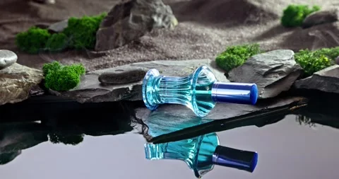 Modern blue perfume in an oasis on stony black desert. Stock-Footage 337072920