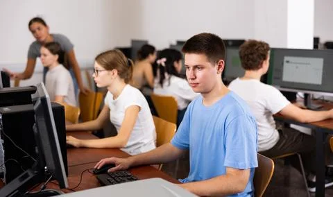Modern boy student learning basics of programming in course in computer college Stock Photos