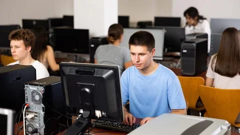 Modern boy student learning basics of programming in course in computer college Stock Photos