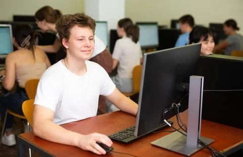 Modern boy student learning basics of programming in course in computer college Stock Photos