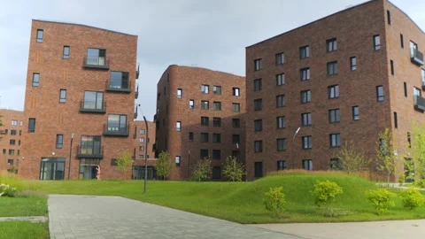 Modern brick apartment buildings feature contemporary design Stock Footage 343590547