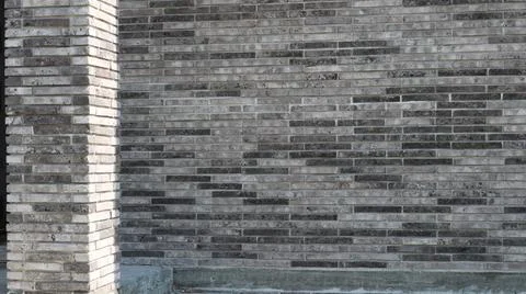 Modern brick building facade with a corner column made of gray brick. Stock-Fotos