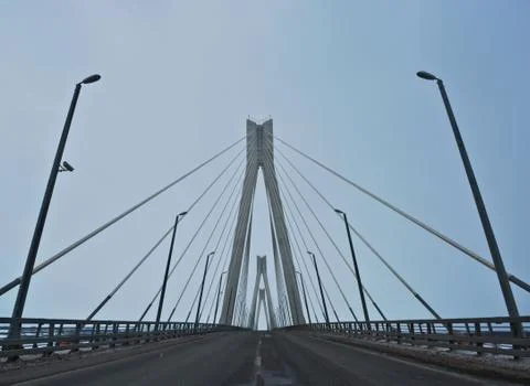 Modern bridge across the river on a cloudy day Stock Photos