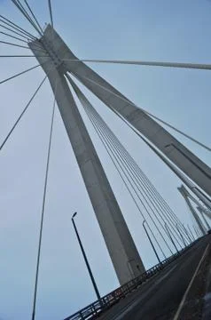 Modern bridge across the river on a cloudy day Stock Photos