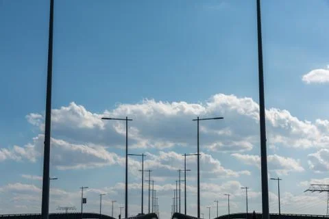 Modern bridge construction with street lighting and blue sky Foto stock