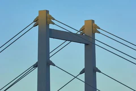 A modern bridge at sunset with clear cable structures and a cloudless sky, Foto stock
