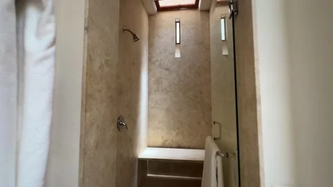 Modern Bright Bathroom with Inviting Shower and Elegant Decor Elements 스톡 동영상 327844722