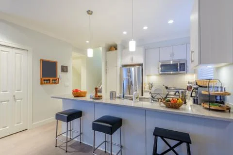 Modern, bright, clean, kitchen interior with stainless steel appliances in a  Stock Photos