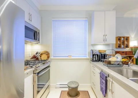 Modern, bright, clean, kitchen interior with stainless steel appliances in a  Stock Photos